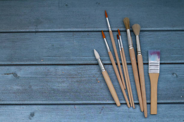 istock Set of artistic paintbrushes on blue background. 1364070229