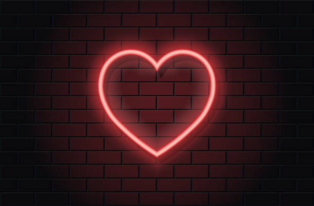 istock Red neon heart for valentines day on black brickwall background 1364071386
