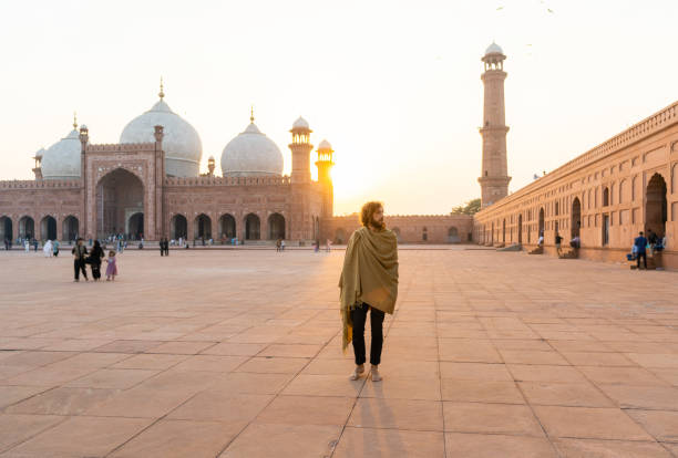 istock Man walking near the mosque in Lahore 1364072908