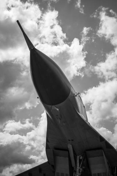 istock Soviet legendary aircraft Mig-29. Bottom view with sky and clouds. 1364073344