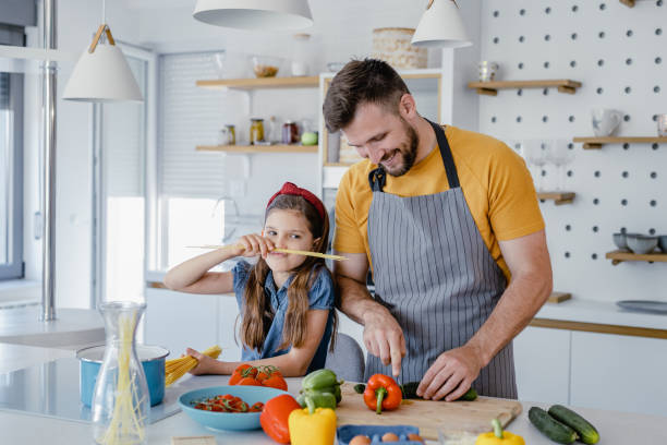 istock Having fun while preparing healthy meal with father in the kitchen 1364074477