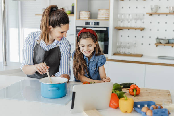 istock Mother and daughter in the kitchen 1364074564