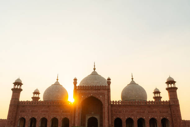 istock Birds flying over mosque in Pakistan at sunset 1364075901