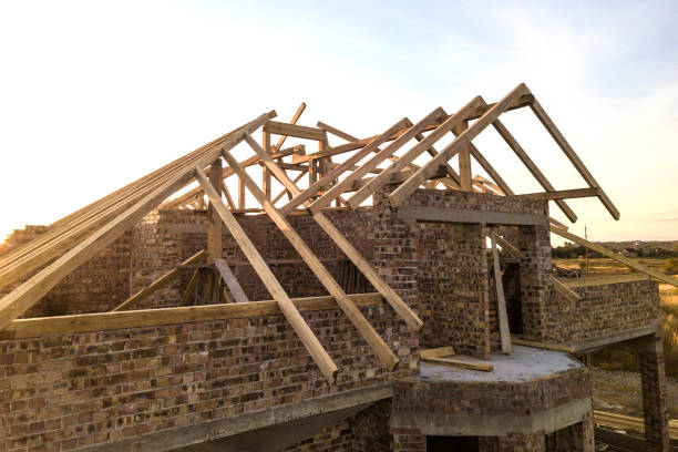 istock Private residential house with wooden roof frame structure under construction. Unfinished brick building under development. 1364080824