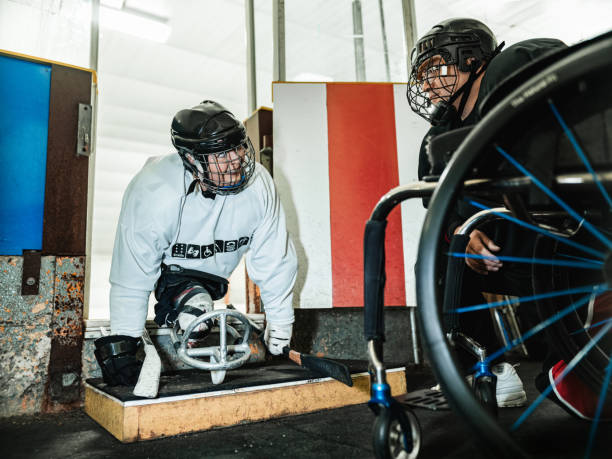 istock Latin woman and her partner after practising sledge hockey 1364084233