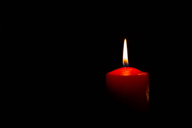 istock one candle burns in the dark 1364088555