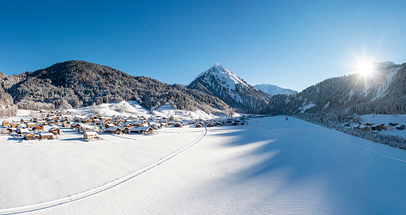 Aerial view panorama of a snow-covered village in the mountains. Vorarlberg, Schoppernau