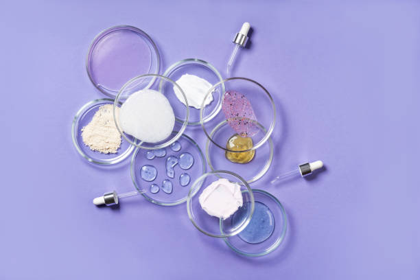 Cosmetic products, scrub, face serum and gel in many petri dishes on a pink background. Cosmetics laboratory research concept. Pastel violet background Cosmetic products, scrub, face serum and gel in many petri dishes on a pink background. Cosmetics laboratory research concept petri dish stock pictures, royalty-free photos & images