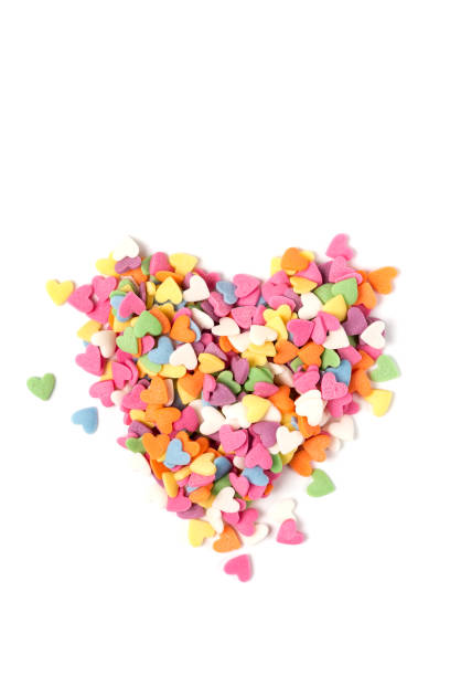 istock Multi-colored heart-shaped pastry topping in heart form on white background, minimalistic 1364092135