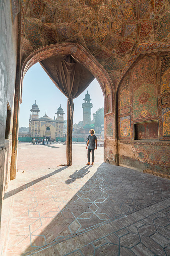 Young Caucasian man  walking in the mosque in Lahore
