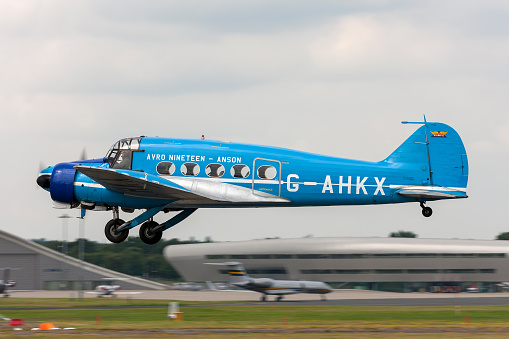 Farnborough, UK - July 17, 2014: Avro 652A Anson twin engine aircraft G-AHKX taking off from Farnborough Airport.