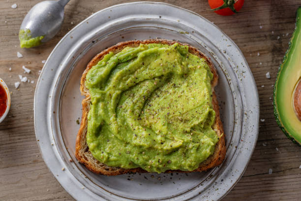 Tasty fresh toast with mashed avocado stock photo