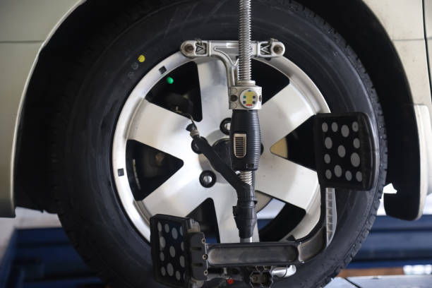 istock Mechanic straightens car wheel rims. 1364100918