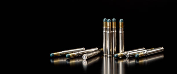 istock Bullet isolated on black background with reflexion. Rifle bullets close-up on black back. Cartridges for rifle and carbine on a black. 1364101215