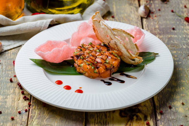 istock salmon Tartar on a plate on wooden table 1364102131