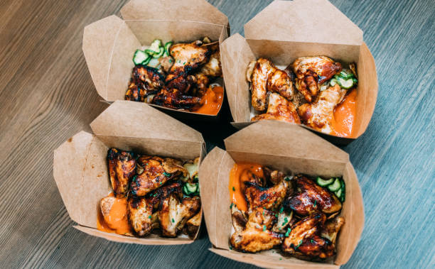 istock Baked chicken wings in a delivery paper box. 1364102900