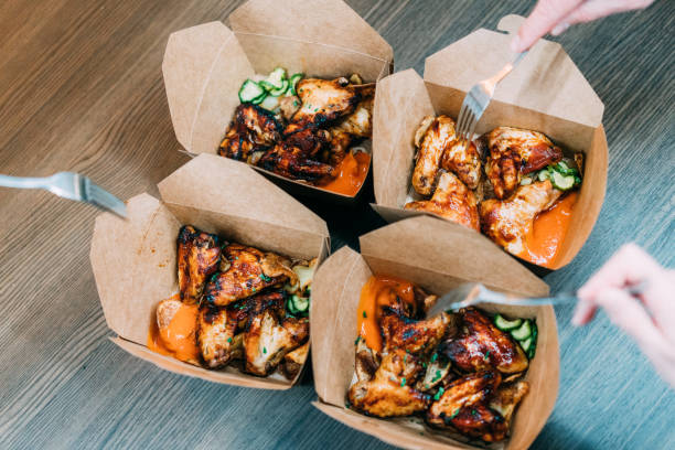 Friends eating chicken wings.