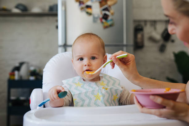 istock Woman Feeding the Baby 1364104453