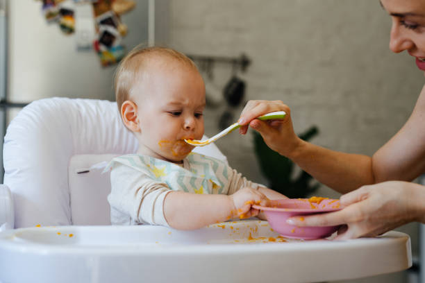 istock Woman Feeding the Baby 1364104468
