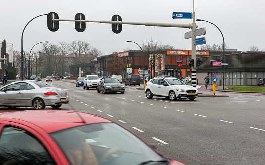 Enschede, Overijssel, Netherlands, december 15th 2021, daytime traffic at the stoplight on the Boddenkampsingel, crossing with the Hengelosestraat downtown Enschede - with a population of 160.000 (2021) the Enschede municipality is the 14th largest in the country