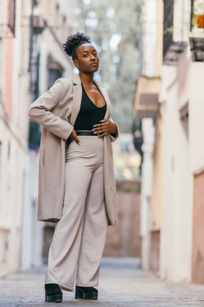 istock Afro woman posing while looking at the camera with a cocky expression outdoors 1364105193