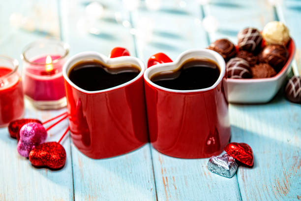 Valentines Day Coffee Cups Pair and Lighting Decorations on Light Blue Retro Wood Background