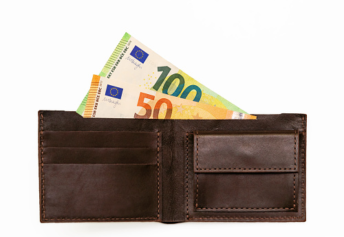 concept of inflation, rising consumer prices. Brown leather wallet and European currency