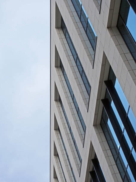 istock angled close up of a modern office building with blue cloudy sky 1364109859