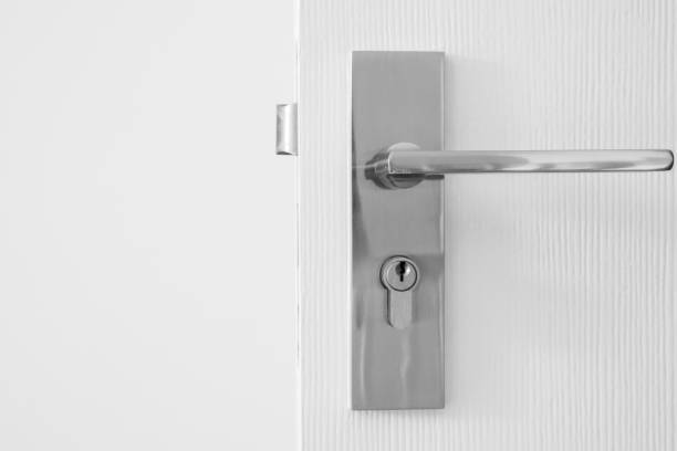 istock Modern door handle with keyhole on white door 1364110620