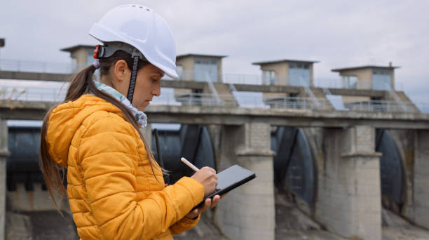 istock Female engineer working in hydroelectric dam. Ecology orientated. Renewable energy systems. 1364110740