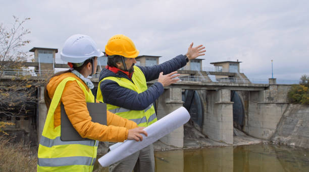 istock Maintenance engineers working in hydroelectric dam. Ecology orientated. Renewable energy systems. 1364110749