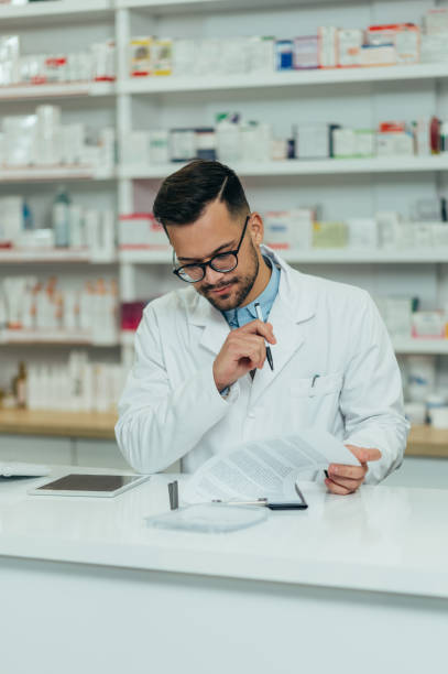 istock Portrait of a handsome pharmacist working in a pharmacy 1364110877