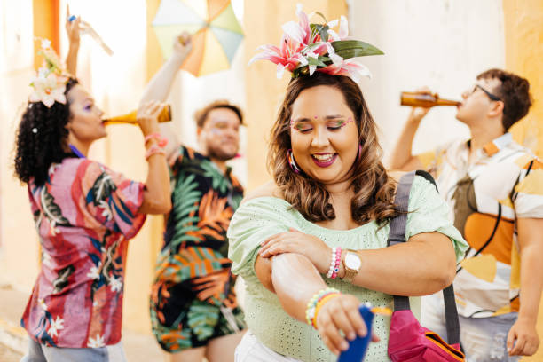 istock Care during Carnival. Young woman using sunscreen during carnival block 1364114271