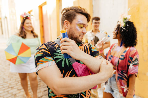 istock Care during Carnival. Man using sunscreen during carnival block 1364114340