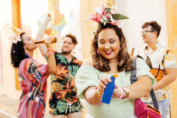 istock Care during Carnival. Young woman using sunscreen during carnival block 1364114342