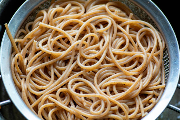 Organic Japanese Noodles on a pan, top view Organic Japanese Noodles on a pan, top view madeira sauce stock pictures, royalty-free photos & images