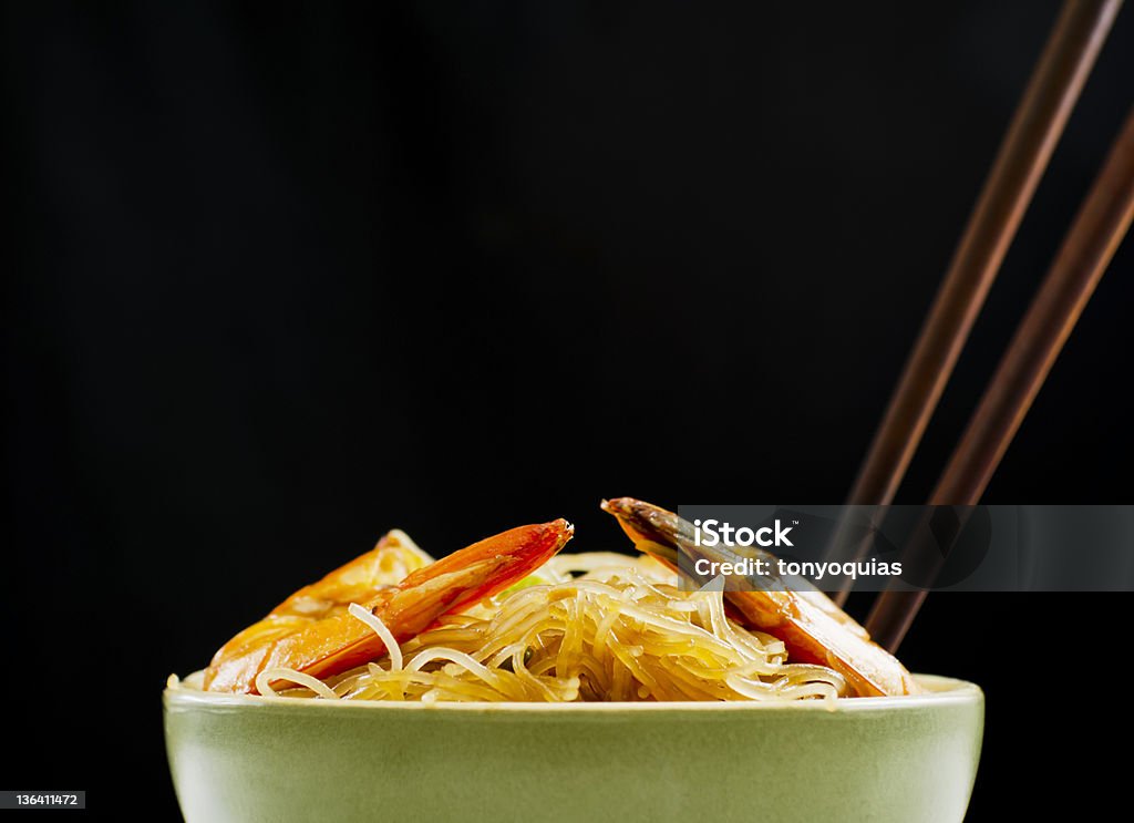 Pansit in Bowl Pansit Bihon, a Filipino noodle dish, on black background Celery Stock Photo