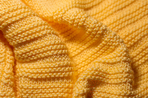 Wavy yellow woolen fabric background