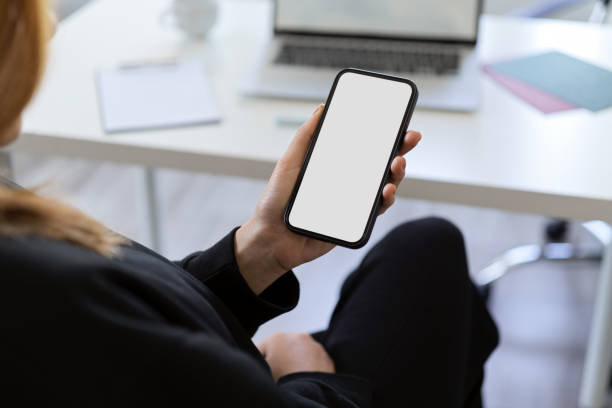 istock A female using a smartphone at her office desk. 1364124972