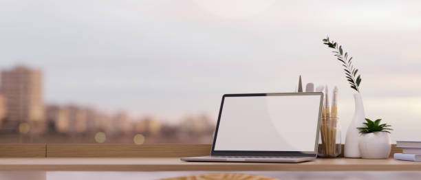 istock Laptop computer mockup and copy space on wooden tabletop 1364125160