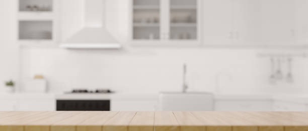 istock A copy space on wooden dining tabletop over blurred modern luxury white kitchen 1364125226