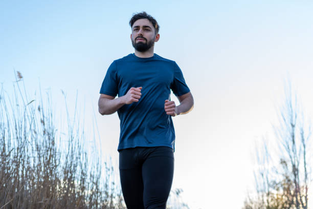 istock Young man jogging in the park 1364126851