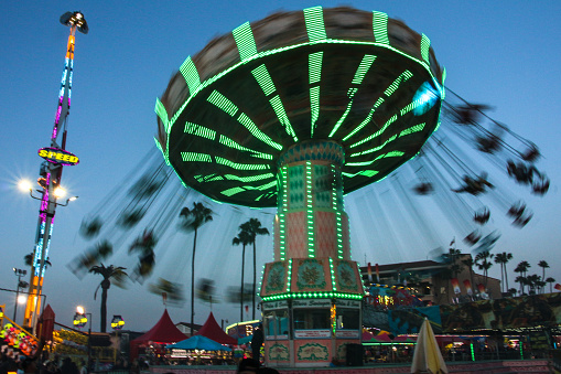 Photograph of a chain swing ride lit up at sunset at the 2018 San Diego County Fair at the Del Mar Fairgrounds.