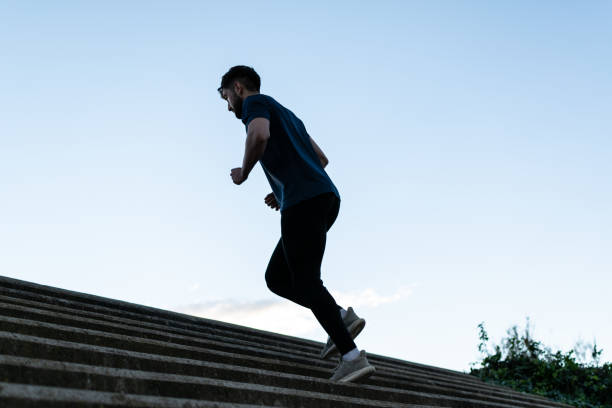 istock Young man running upstairs in park 1364127417