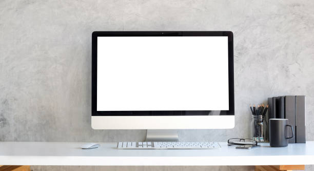 istock Computer with blank white display and supplies on white table.