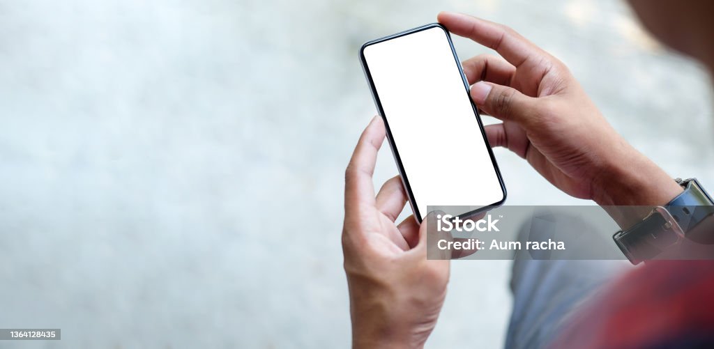 Close up view of businessman holding mock up smart phone with blank screen."t Brand Name Smart Phone Stock Photo