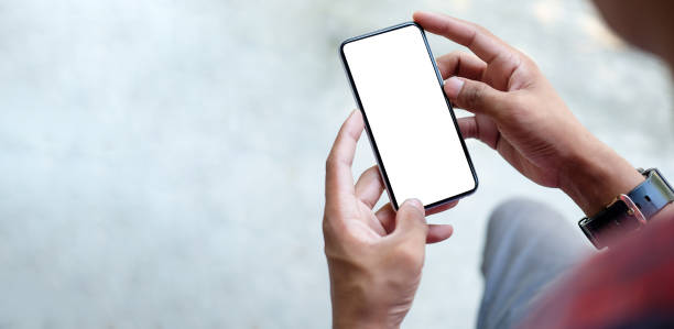 Close up view of businessman holding mock up smart phone with blank screen."t Close up view of businessman holding mock up smart phone with blank screen."t brand name smart phone photos stock pictures, royalty-free photos & images