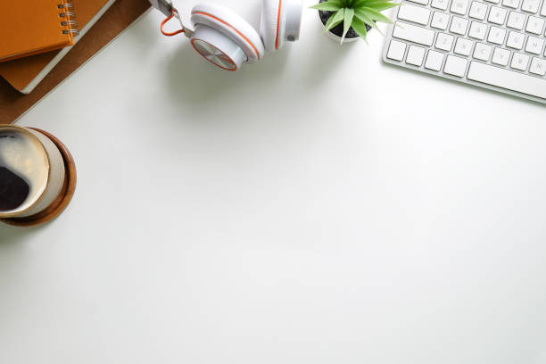 istock Top view books, and cop of coffee on table. Office desk. 1364128475