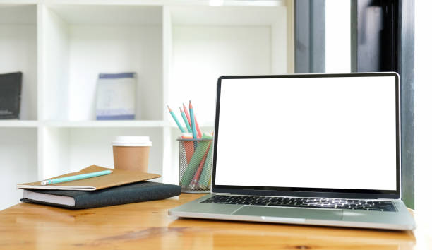 istock Computer laptop, cactus, pencil holder and books on wooden table.