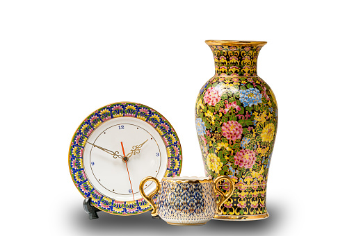 Benjarong clock, vase and jar isolated on white background with clipping path. Benjarong, the beautiful Thai traditional porcelain. Thai porcelain design in five colors called Benjarong.